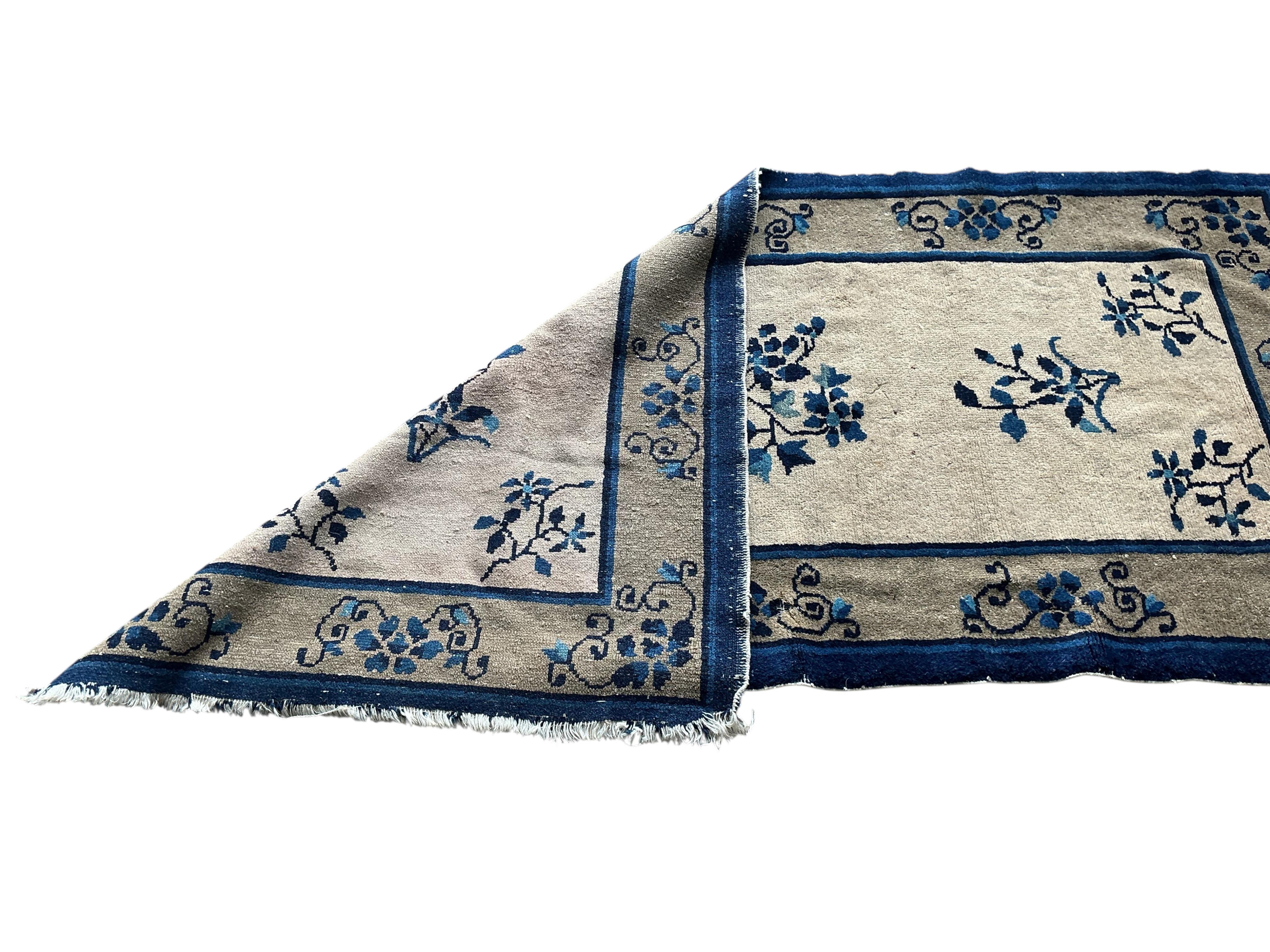 A Chinese fawn ground floral rug, 160 x 78cm